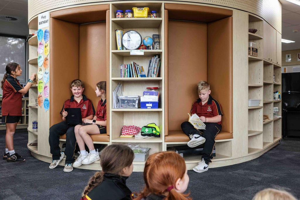 Students enjoying time playing games and reading books in a classroom at the Evanston Campus.