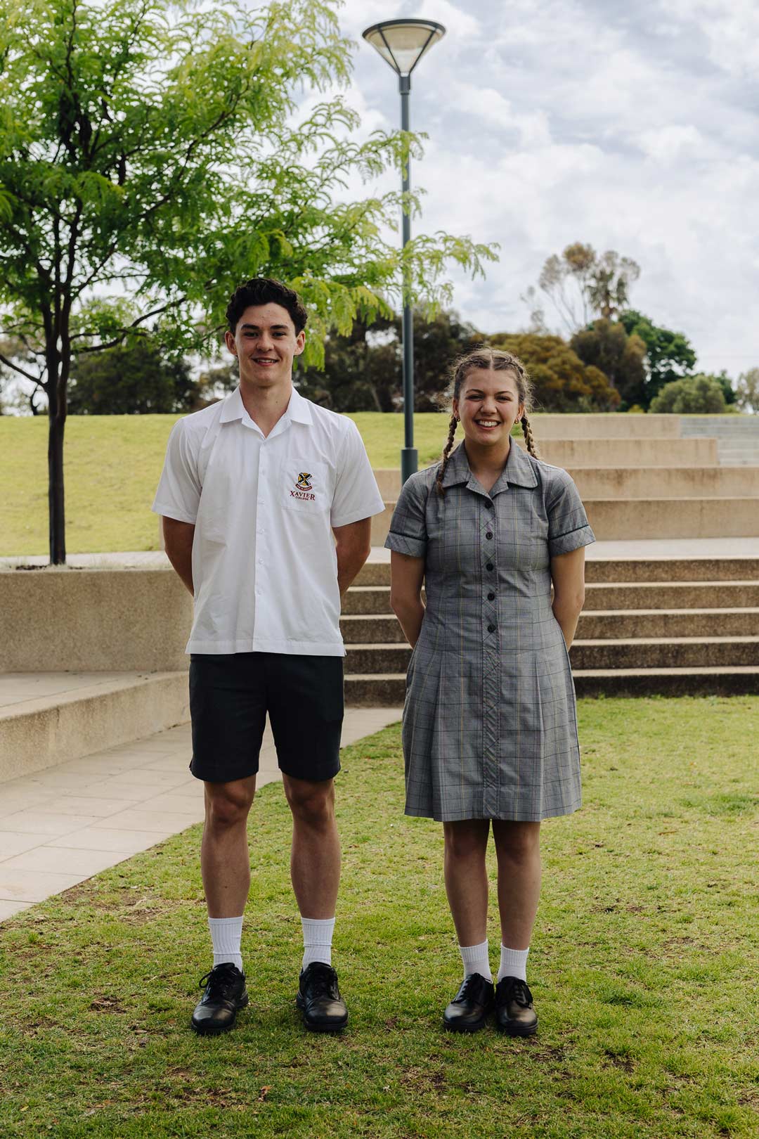 Two students modelling the formal summer uniform, both Option A and B.