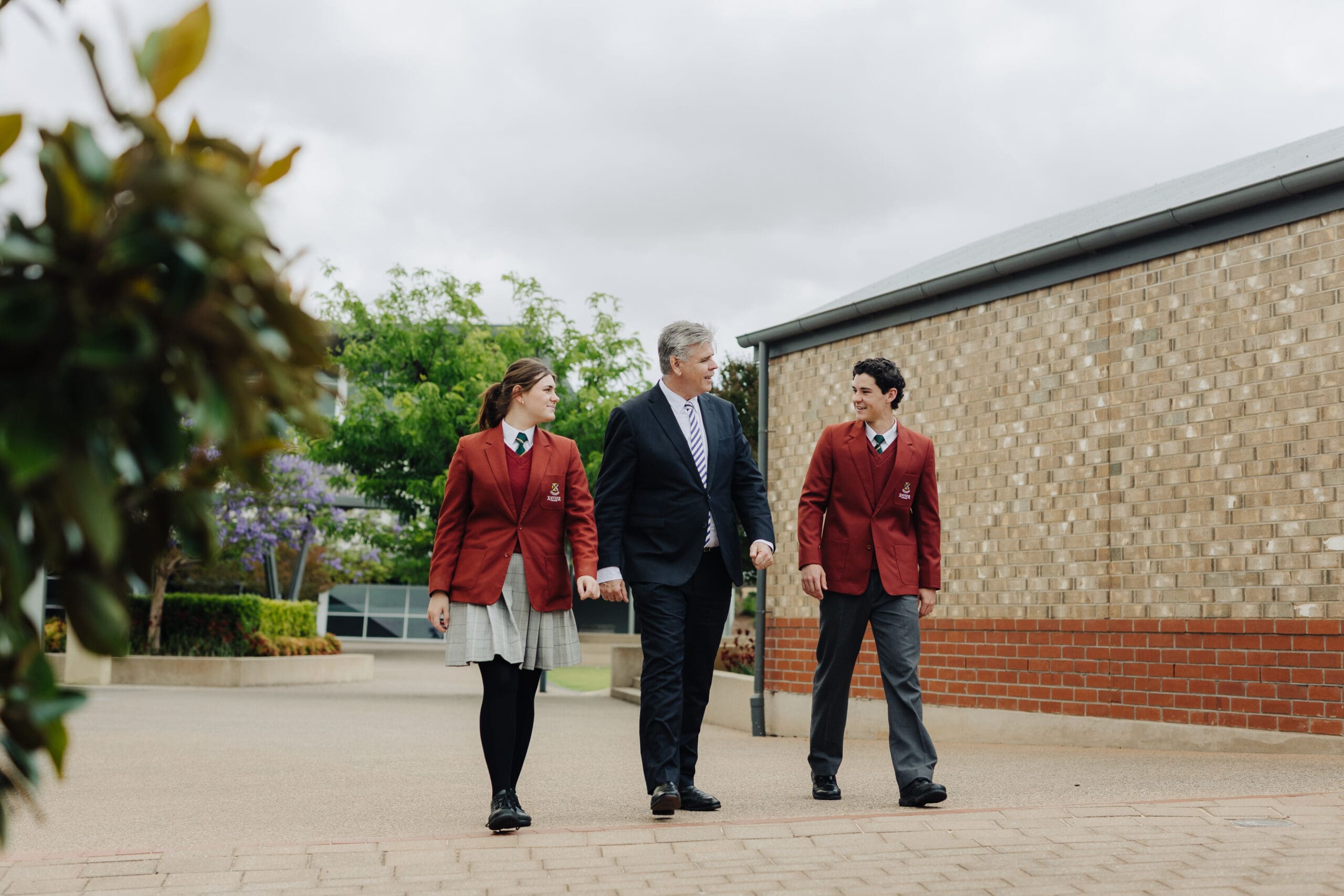 Gawler Belt Head of Campus John Cameron walking with senior students through the courtyard of the Gawler Belt Campus. 