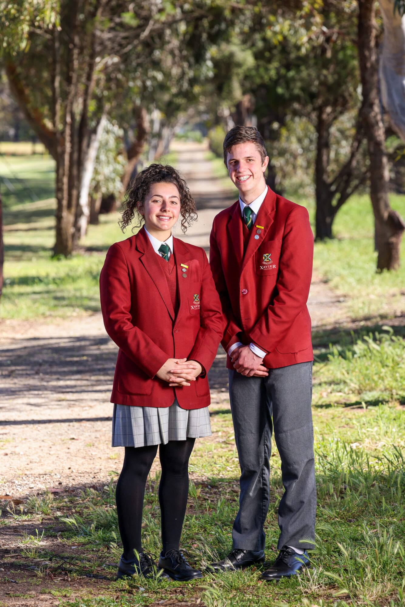 Two students modelling the formal winter uniform, both Option A and B.