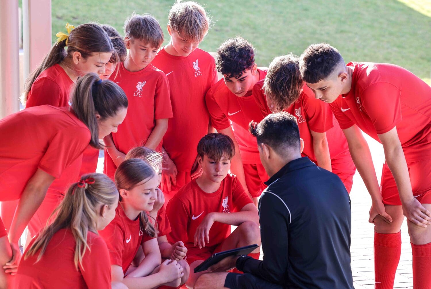 Students in Liverpool uniforms being shown a training video