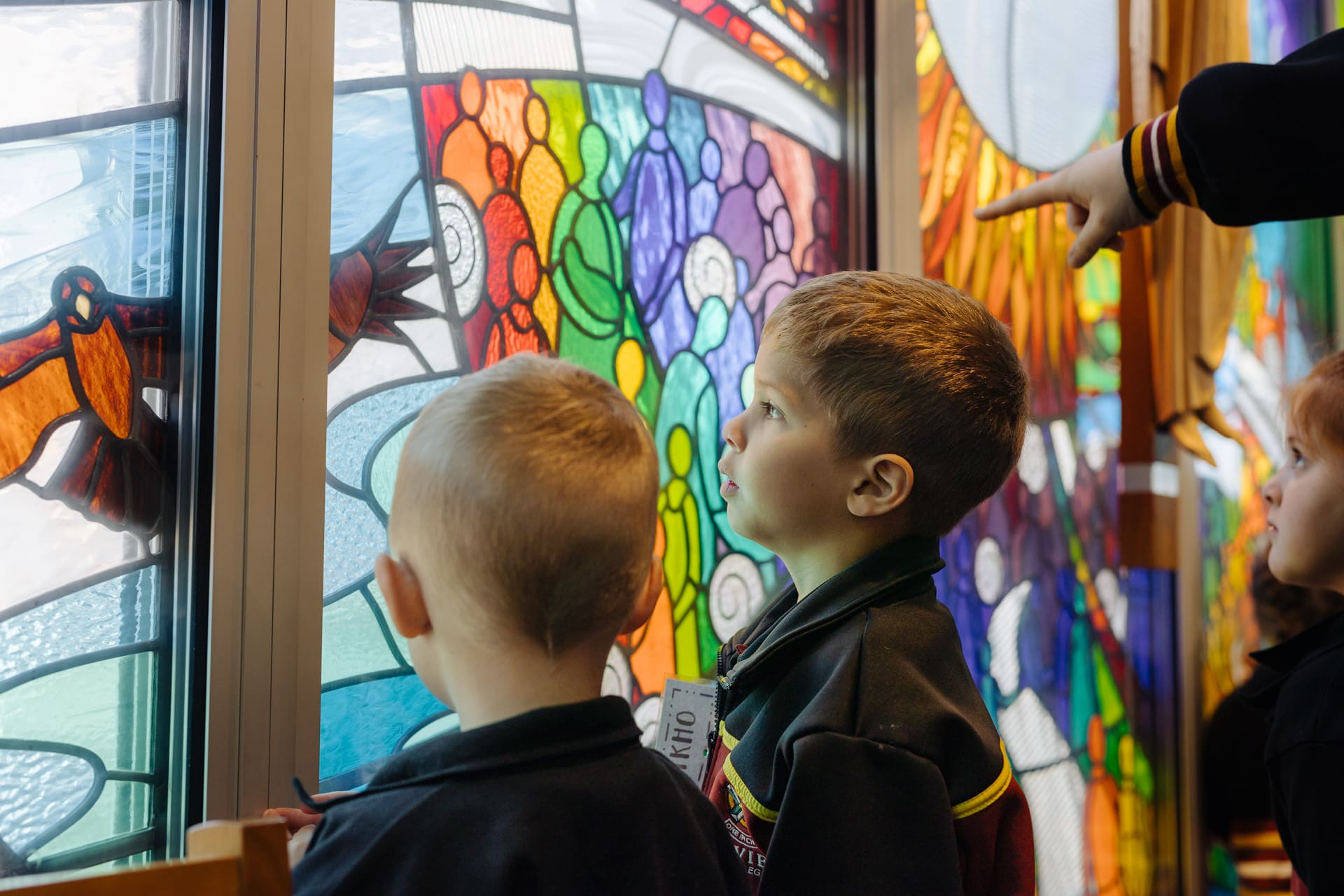 Students studying the detail of the pane glass window in the Gawler Belt Campus Chapel.