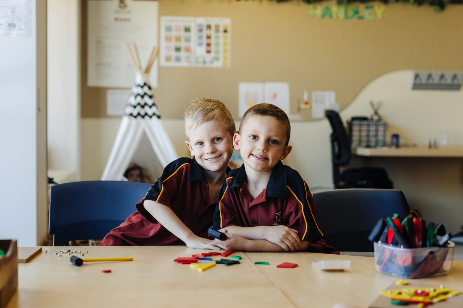 Early Years students smiling as they do colourful activities in class.